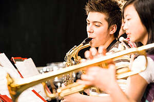 teenagers playing the trumpet