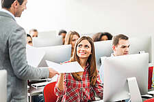 woman receiving assignment from professor